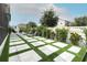 Backyard featuring stone pavers with artificial grass, lounge chairs, and lush landscaping at 15849 Sweet Lemon Way, Winter Garden, FL 34787