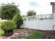 Backyard features a white privacy fence, brick-paved pathway, and lush greenery at 15849 Sweet Lemon Way, Winter Garden, FL 34787