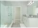 Bathroom featuring a luxurious glass-enclosed shower and vanity with stone countertops at 15849 Sweet Lemon Way, Winter Garden, FL 34787