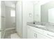 Bathroom with shower, white vanity and granite counters at 15849 Sweet Lemon Way, Winter Garden, FL 34787