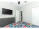 Bedroom with TV, gray dresser and view into the hallway at 15849 Sweet Lemon Way, Winter Garden, FL 34787