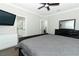 Primary bedroom with a ceiling fan, TV, dresser, mirror and an ensuite bathroom at 15849 Sweet Lemon Way, Winter Garden, FL 34787