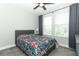 Bedroom with neutral paint, carpet, two windows and floral comforter at 15849 Sweet Lemon Way, Winter Garden, FL 34787