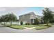 View of the side of a two-story home featuring a well-maintained lawn and a white fenced yard at 15849 Sweet Lemon Way, Winter Garden, FL 34787
