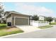Beige exterior of home featuring a two-car garage and driveway at 15849 Sweet Lemon Way, Winter Garden, FL 34787