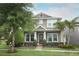Charming two-story home with a well-manicured lawn, lush landscaping, and inviting front porch at 15849 Sweet Lemon Way, Winter Garden, FL 34787