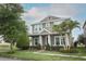 Charming two-story home with a well-manicured lawn, lush landscaping, and inviting front porch at 15849 Sweet Lemon Way, Winter Garden, FL 34787