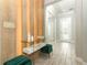 Bright and airy foyer features wood-look tile flooring, decorative wall accents, and a glass front door at 15849 Sweet Lemon Way, Winter Garden, FL 34787