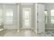 The foyer features a decorative glass door and wood-look tile, creating a bright and welcoming entrance at 15849 Sweet Lemon Way, Winter Garden, FL 34787