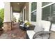 Charming front porch with brick flooring and cozy outdoor seating, perfect for relaxing at 15849 Sweet Lemon Way, Winter Garden, FL 34787