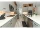 A modern kitchen showcasing sleek gray cabinets, stainless steel appliances and tiled backsplash at 15849 Sweet Lemon Way, Winter Garden, FL 34787