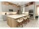 This gourmet kitchen features a large island, stainless steel appliances, and stylish decor at 15849 Sweet Lemon Way, Winter Garden, FL 34787