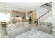 Open-concept living space featuring kitchen, dining area, staircase and comfortable seating at 15849 Sweet Lemon Way, Winter Garden, FL 34787