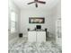 Bright office space with stylish art, sleek white desk, and plush gray rug offers a modern workspace at 15849 Sweet Lemon Way, Winter Garden, FL 34787