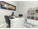 The office space boasts unique art, a sleek desk, and a decorative display shelf adding personality at 15849 Sweet Lemon Way, Winter Garden, FL 34787