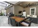 The outdoor patio features a dining area, stainless steel grill, seating area, and TV for entertainment at 15849 Sweet Lemon Way, Winter Garden, FL 34787