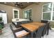 Outdoor patio with dining table, seating, ceiling fan, and sliding glass doors provide great entertaining space at 15849 Sweet Lemon Way, Winter Garden, FL 34787