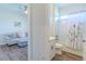 Bathroom with a white vanity, tub with a white subway tile surround and view into a living room at 1598 Whitewood Ct, Kissimmee, FL 34747