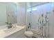 Bright bathroom featuring a tub with white subway tile surround, a shower, and a white vanity at 1598 Whitewood Ct, Kissimmee, FL 34747
