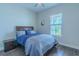 Relaxing bedroom with wood floors, a window, and a comfortable queen-sized bed at 1598 Whitewood Ct, Kissimmee, FL 34747