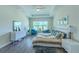 A bright main bedroom with white furniture and ample seating in front of a window overlooking the outdoors at 1598 Whitewood Ct, Kissimmee, FL 34747