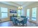 Elegant dining room featuring a modern chandelier, large windows, and comfortable seating at 1598 Whitewood Ct, Kissimmee, FL 34747