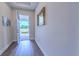 Inviting entryway with wood-look floors and an open view of the outdoors at 1598 Whitewood Ct, Kissimmee, FL 34747