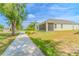 A bright and airy exterior view features a screened in lanai and green lawn, complementing the home's facade at 1598 Whitewood Ct, Kissimmee, FL 34747