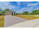 Well-manicured home featuring a paver driveway, two car garage, and beautiful landscaping at 1598 Whitewood Ct, Kissimmee, FL 34747