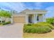 Charming single-story home with a well-manicured lawn and a welcoming front porch at 1598 Whitewood Ct, Kissimmee, FL 34747