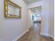 Hallway with wood floors leads to the living area, creating an open and inviting space at 1598 Whitewood Ct, Kissimmee, FL 34747