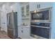 Close-up of stainless steel kitchen appliances including refrigerator, microwave, and oven at 1598 Whitewood Ct, Kissimmee, FL 34747