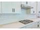 Gas cooktop on a light countertop against subway tile backsplash in a modern kitchen at 1598 Whitewood Ct, Kissimmee, FL 34747