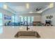 Modern kitchen featuring a large island, stainless steel sink, and open floor plan at 1598 Whitewood Ct, Kissimmee, FL 34747
