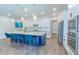 Modern kitchen features a large island with seating, stainless steel appliances, and ample counter space at 1598 Whitewood Ct, Kissimmee, FL 34747