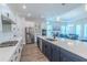 Well-lit kitchen features an island with sink, stainless steel appliances, and wood flooring at 1598 Whitewood Ct, Kissimmee, FL 34747
