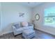 Cozy living room features neutral colors, wood floors, and a large window with natural light at 1598 Whitewood Ct, Kissimmee, FL 34747