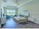 Bright main bedroom with tray ceiling, ceiling fan, and blue accent furniture at 1598 Whitewood Ct, Kissimmee, FL 34747