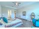 Spacious main bedroom featuring wood floors, blue accent chair, and a tray ceiling at 1598 Whitewood Ct, Kissimmee, FL 34747