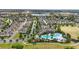 Aerial view showcasing community with a resort-style pool, walking paths, and manicured green spaces at 16163 Pebble Bluff Loop, Winter Garden, FL 34787