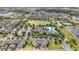 Community aerial shot with a clubhouse, swimming pool, and a park surrounded by many homes at 16163 Pebble Bluff Loop, Winter Garden, FL 34787
