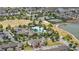 Beautiful aerial view of community amenities including a pool, tennis court, and pristine landscaping surrounding the homes at 16163 Pebble Bluff Loop, Winter Garden, FL 34787