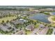 Community aerial shot featuring a pool, clubhouse, tennis court, ponds, and numerous homes at 16163 Pebble Bluff Loop, Winter Garden, FL 34787