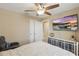 Comfortable bedroom featuring a ceiling fan, television, and neutral decor at 16163 Pebble Bluff Loop, Winter Garden, FL 34787