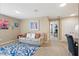 Inviting bonus room features a comfortable sofa, colorful decor, and a stylish blue rug at 16163 Pebble Bluff Loop, Winter Garden, FL 34787
