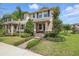 Charming two-story townhome with a beautifully landscaped front yard and inviting entryway at 16163 Pebble Bluff Loop, Winter Garden, FL 34787