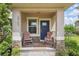 Charming front porch with stone accents and cozy seating, perfect for relaxing at 16163 Pebble Bluff Loop, Winter Garden, FL 34787