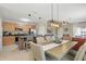 Bright kitchen featuring wooden cabinets, a large island with bar seating, and open access to the living area at 16163 Pebble Bluff Loop, Winter Garden, FL 34787