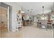 Spacious open-concept living area featuring tile flooring, a kitchen island, and abundant natural light at 16163 Pebble Bluff Loop, Winter Garden, FL 34787