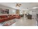 Bright open-concept living area with tile floors, comfortable sofa and views into kitchen and dining at 16163 Pebble Bluff Loop, Winter Garden, FL 34787